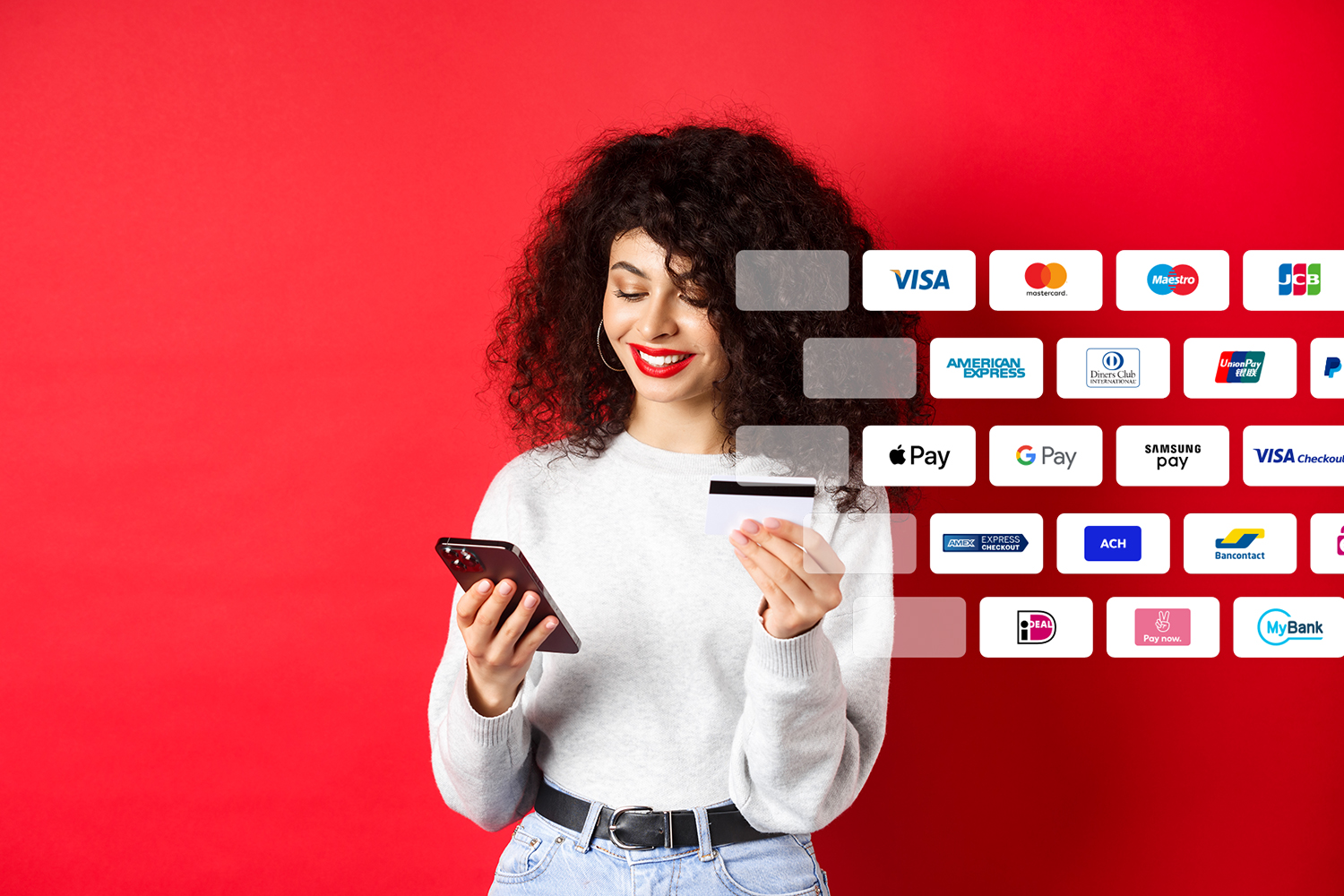 E-commerce and online shopping concept. Attractive caucasian woman paying for purchase in internet, holding smartphone and credit card, red background.